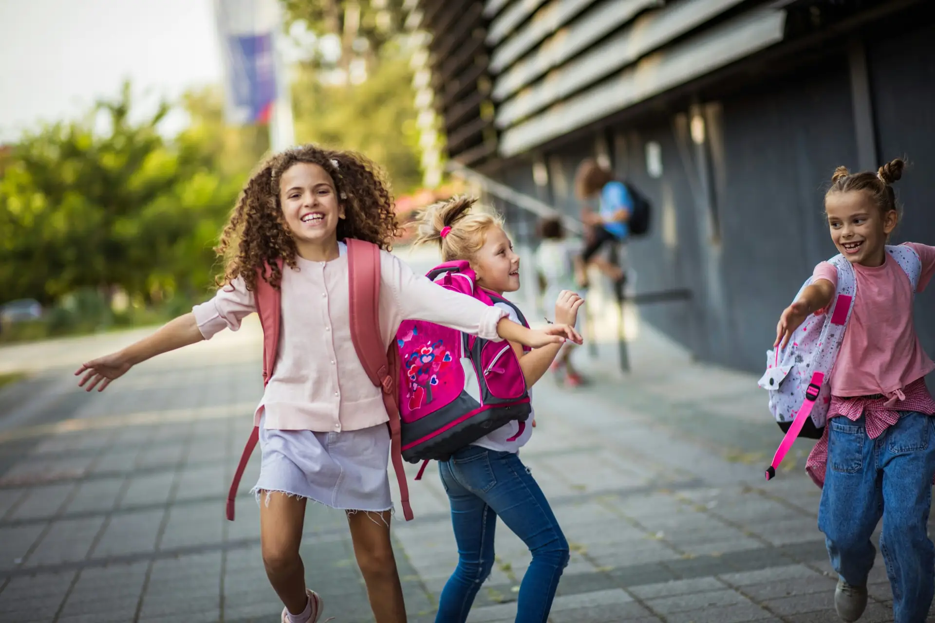 girls walking on sidewalk